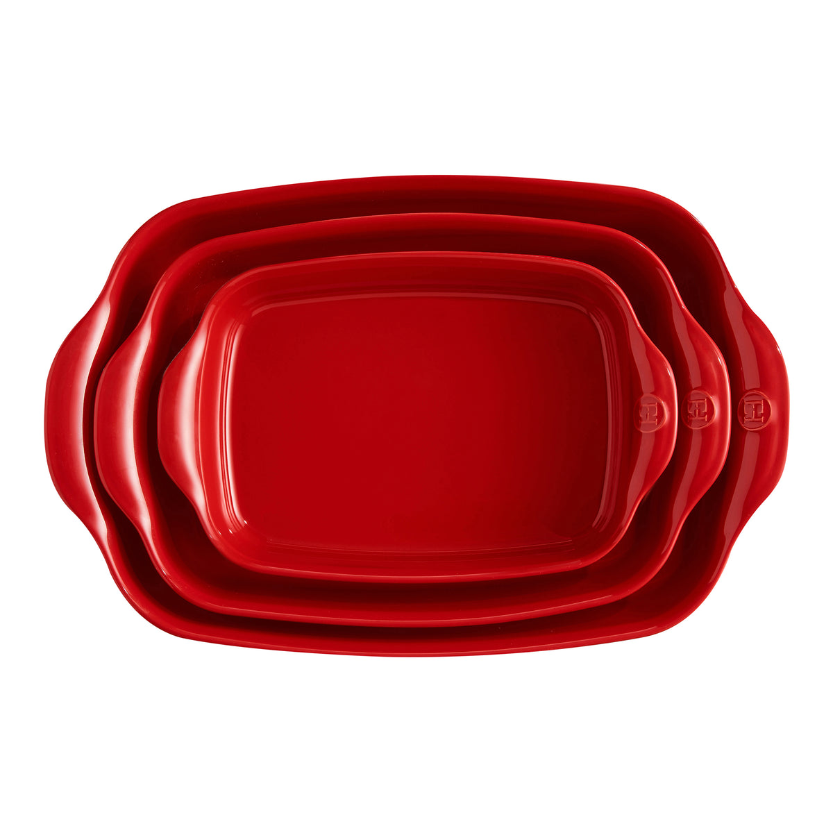 Three nested rectangular red ceramic baking pans with wavy handles, shown from a top-down view on a white background.