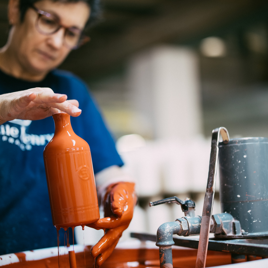 An Emile Henry artisan hand-glazing ceramic at the atelier in Burgundy, France