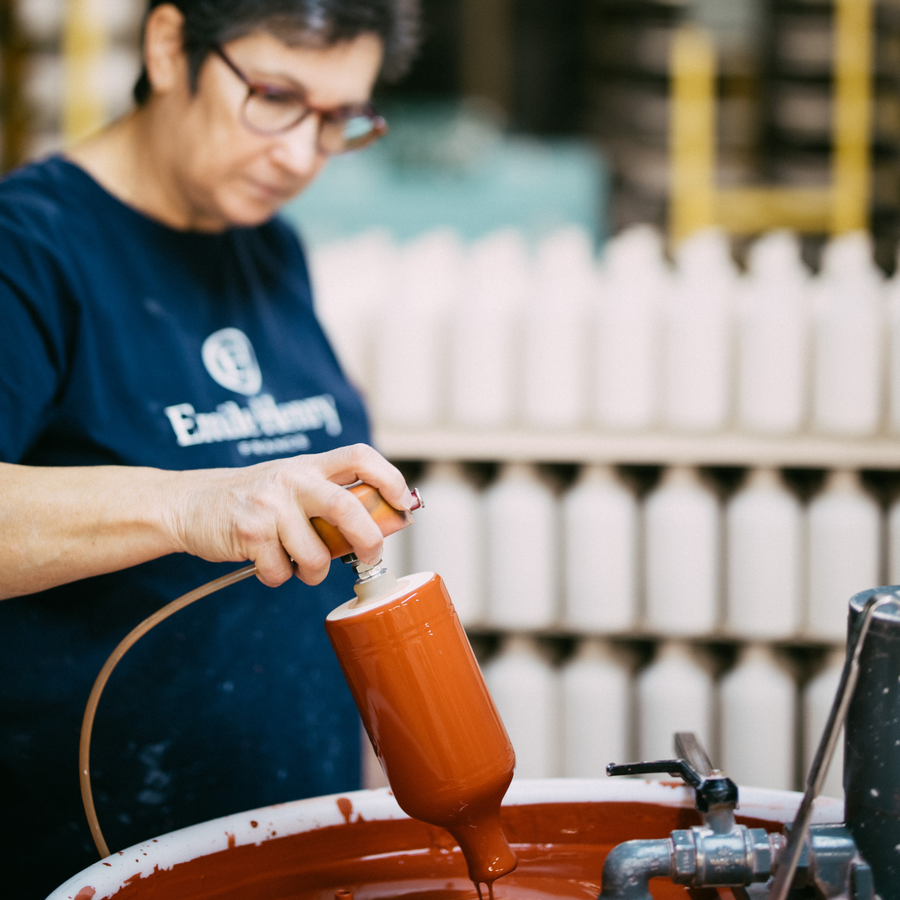 An Emile Henry artisan hand-glazing ceramic at the atelier in Burgundy, France