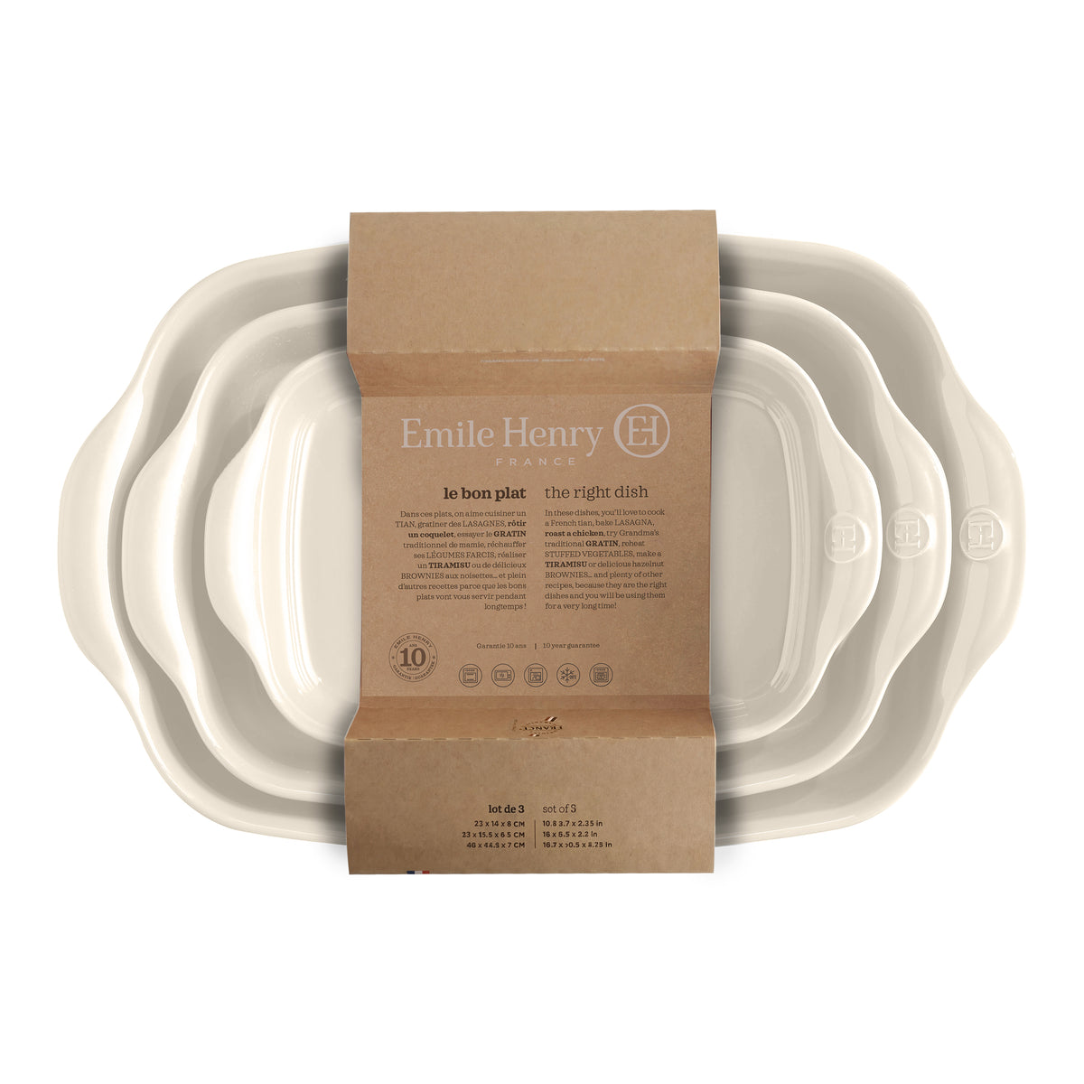 Three nested Emile Henry Le Bon Plat t dishes in a warm off-white/cream color, packaged with a brown cardboard sleeve on a white background.