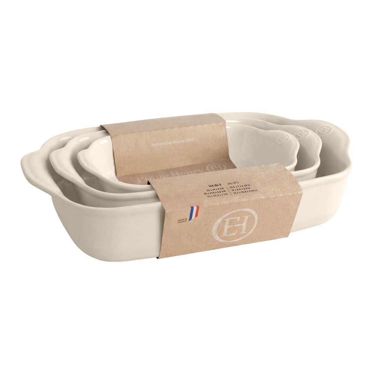 A set of nested cream-colored ceramic baking pans, wrapped in a brown kraft paper band. 