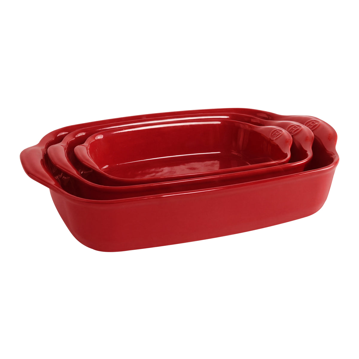 Three nested rectangular red ceramic baking pans with handles, shown on a plain white background.